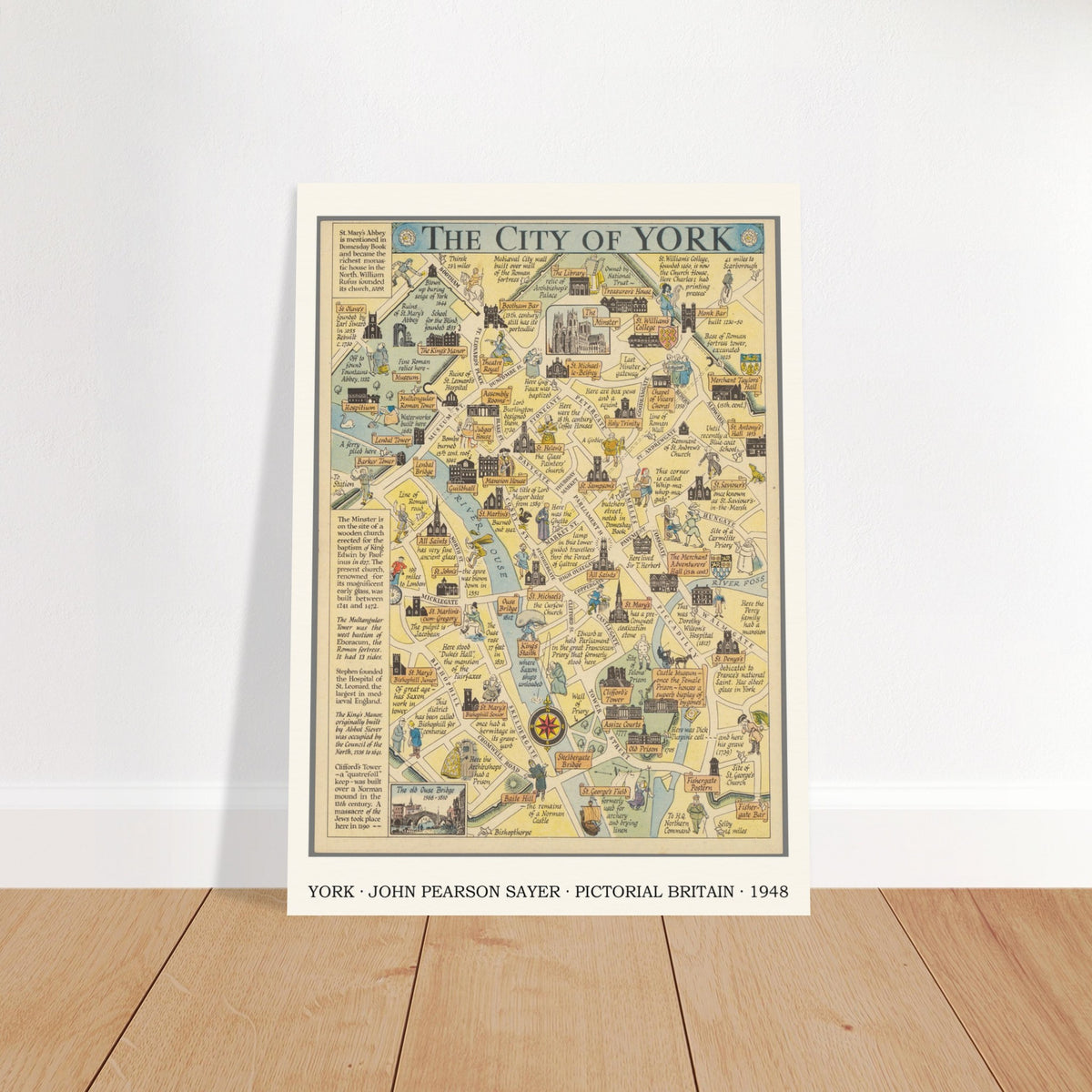 York pictorial map print leaning against a white wall on a wooden floor